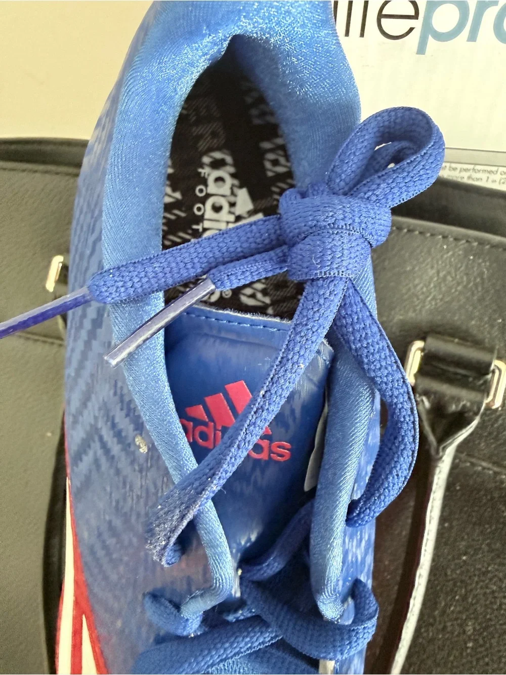 Adidas Blue and Red Cleats